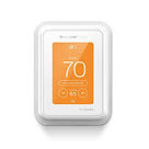 A digital wall thermostat with a white frame displays a temperature of 70 degrees on an orange screen.